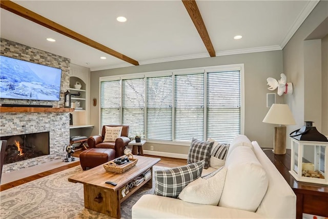 living area with ornamental molding, wood finished floors, built in shelves, a fireplace, and beam ceiling