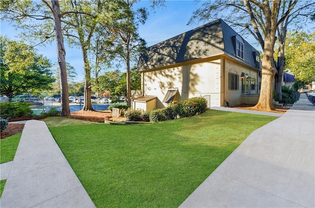 view of property exterior featuring a lawn