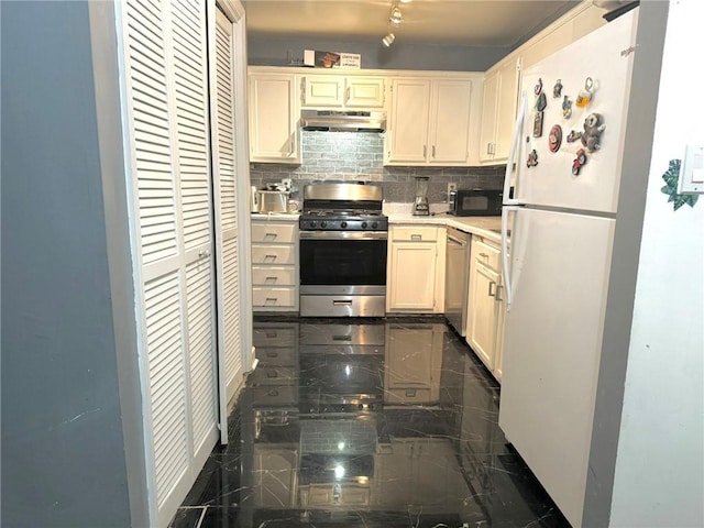 kitchen featuring tasteful backsplash, white cabinetry, and stainless steel appliances