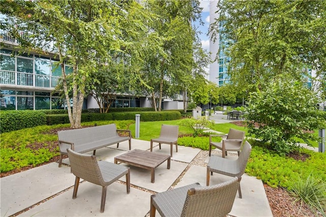 surrounding community featuring an outdoor living space and a patio area