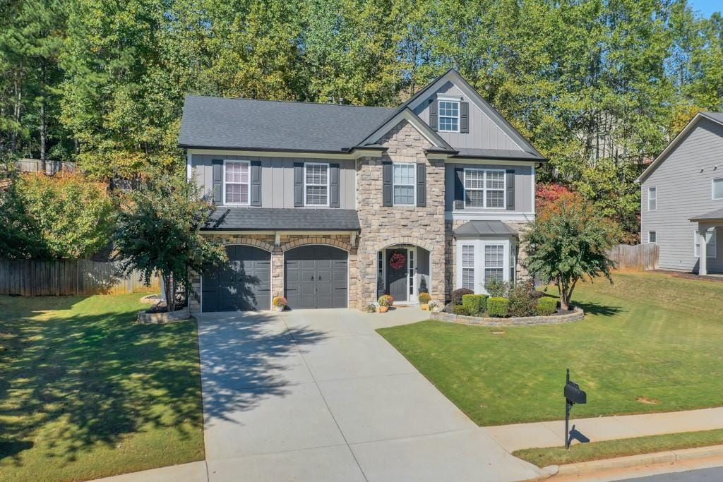 view of front of house with a front yard and a garage