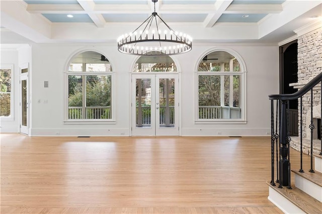 interior space with beamed ceiling, a healthy amount of sunlight, and coffered ceiling