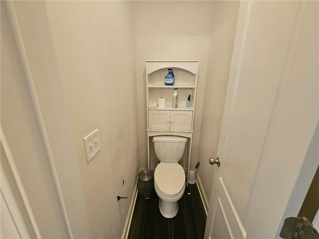 bathroom with baseboards and toilet