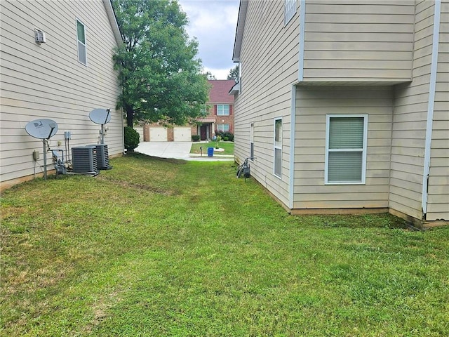 view of green lawn with cooling unit