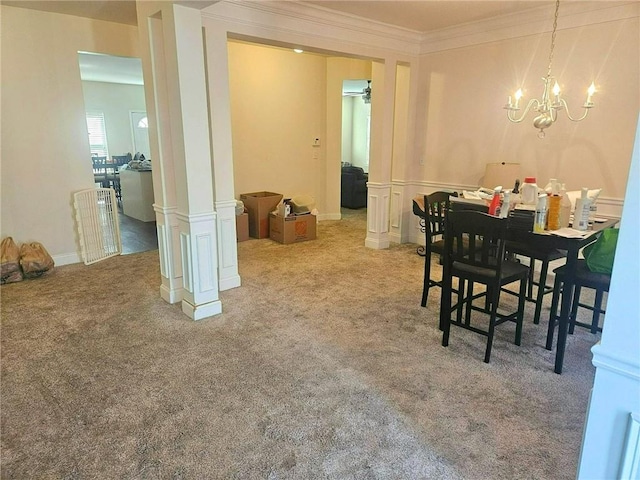 dining space with carpet, ornamental molding, and a chandelier