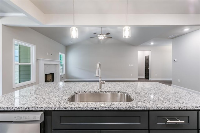 kitchen with a center island with sink, dishwasher, pendant lighting, and sink