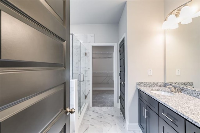 bathroom featuring vanity and a shower with door