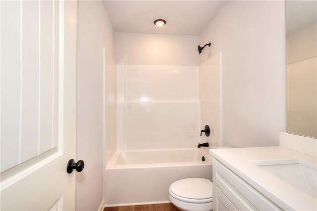 full bathroom featuring bathtub / shower combination, vanity, and toilet