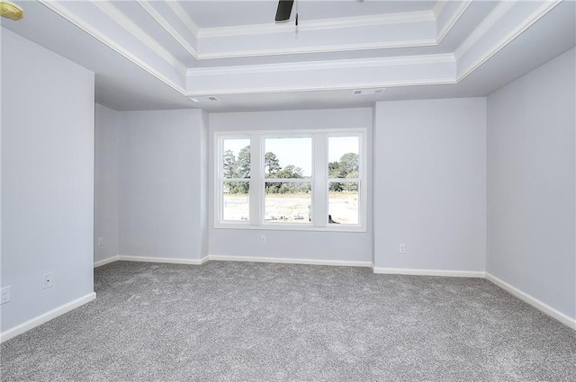 unfurnished room with carpet flooring, a raised ceiling, baseboards, and crown molding