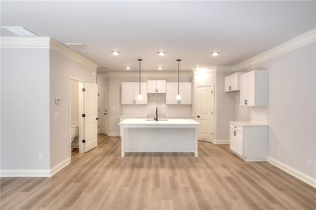 kitchen featuring light hardwood / wood-style floors, a center island with sink, sink, and white cabinetry