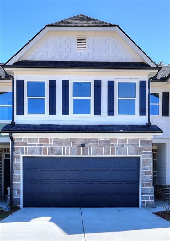 view of front of property with stone siding and driveway