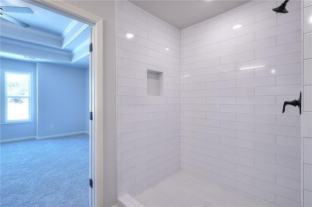 full bathroom with a tile shower, crown molding, and baseboards