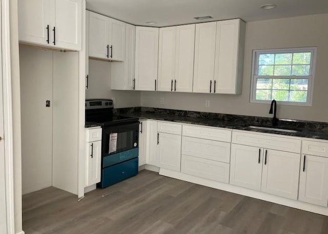 kitchen featuring sink, white cabinets, dark hardwood / wood-style floors, and stainless steel range with electric stovetop