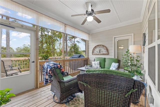 sunroom featuring ceiling fan