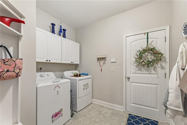 washroom featuring cabinets and washing machine and clothes dryer