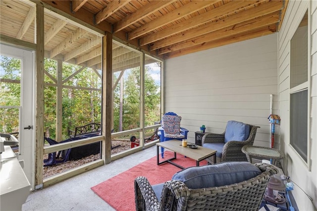 sunroom with a wealth of natural light, wood ceiling, and beam ceiling