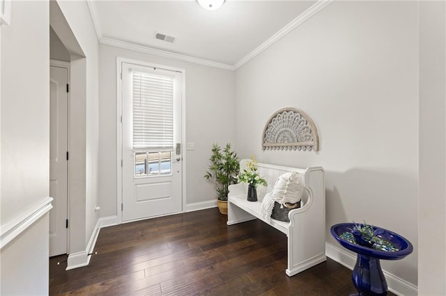 foyer entrance with ornamental molding and dark wood-type flooring