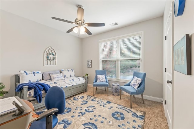 bedroom with ceiling fan, carpet floors, and multiple windows