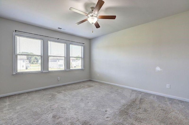 unfurnished room with ceiling fan and light colored carpet