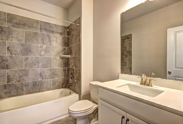 full bathroom featuring tile patterned floors, vanity, toilet, and tiled shower / bath