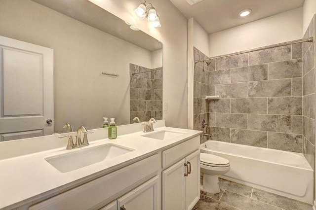 full bathroom featuring vanity, toilet, and tiled shower / bath