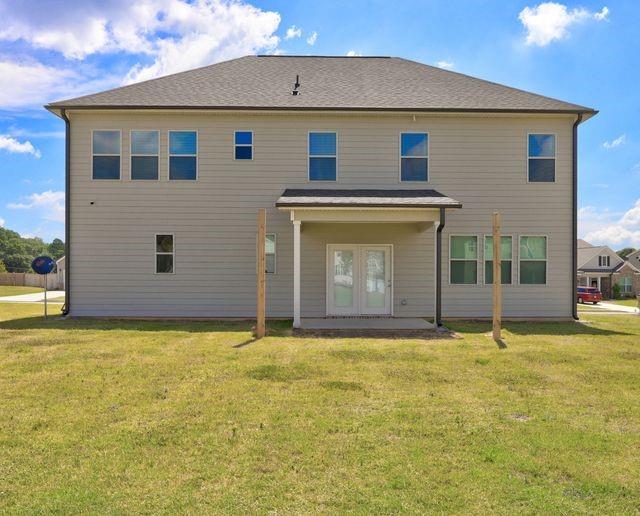 rear view of house featuring a patio area and a yard