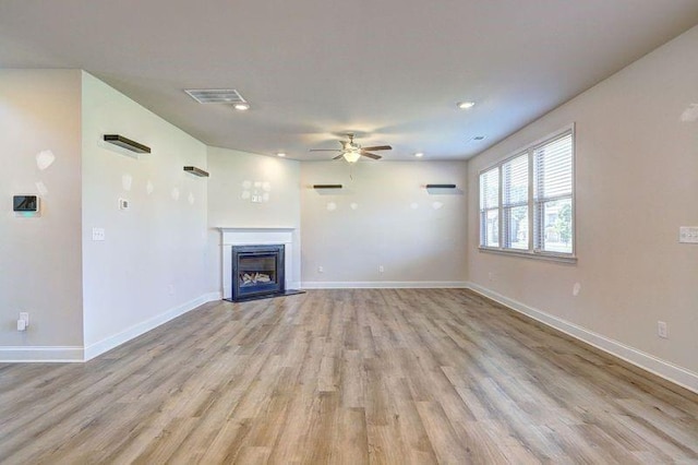 unfurnished living room with light hardwood / wood-style floors and ceiling fan