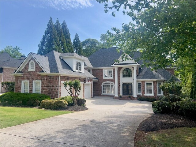 640 Greenview Ter, Milton, GA 30004 - greek revival house featuring concrete driveway, brick siding, a front yard, and a garage