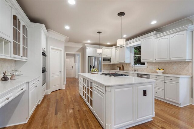 640 Greenview Ter, Milton, GA 30004 - kitchen featuring appliances with stainless steel finishes, white cabinetry, glass insert cabinets, a center island, and decorative backsplash