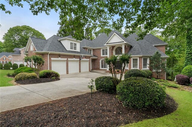 640 Greenview Ter, Milton, GA 30004 - view of front of home with brick siding, concrete driveway, roof with shingles, and a front yard