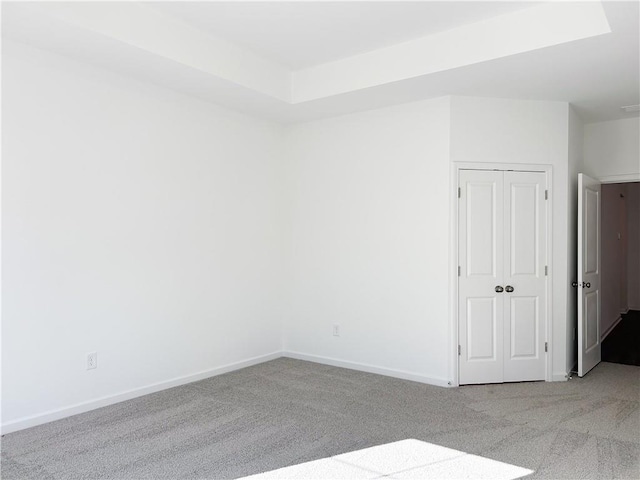 unfurnished room featuring light colored carpet