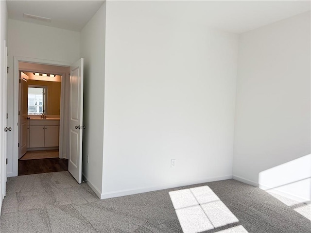 carpeted spare room featuring sink