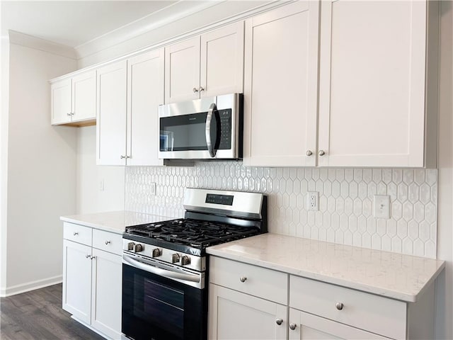 kitchen featuring light stone countertops, white cabinets, and appliances with stainless steel finishes