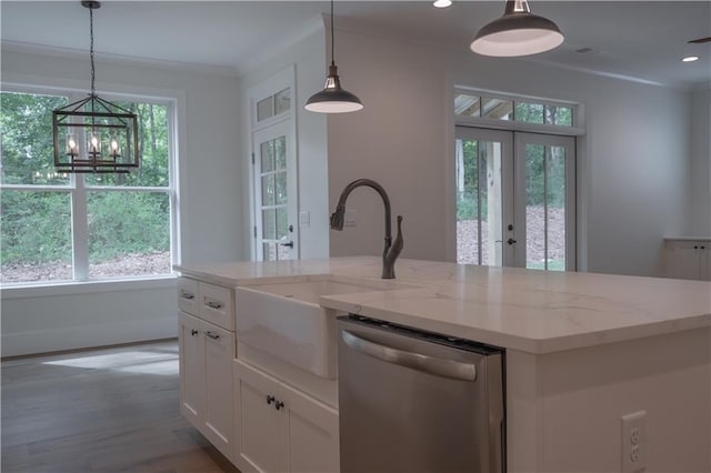 kitchen with white cabinetry, dishwasher, a kitchen island with sink, and hanging light fixtures