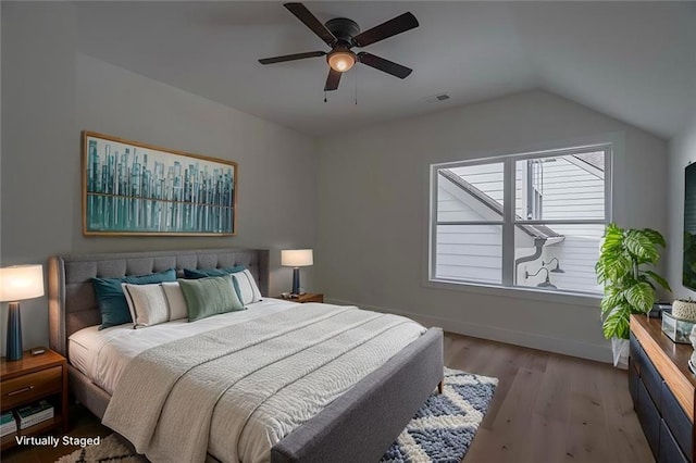 bedroom with lofted ceiling, light hardwood / wood-style flooring, and ceiling fan