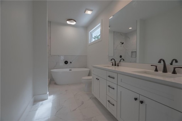 full bathroom featuring vanity, toilet, and separate shower and tub