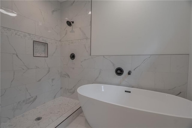 bathroom with tile walls and shower with separate bathtub