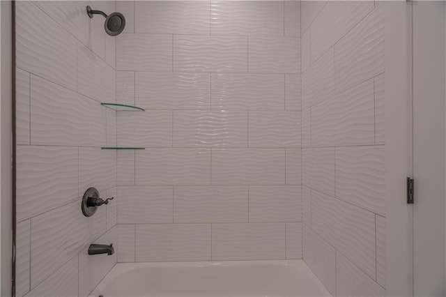 interior details with tiled shower / bath combo