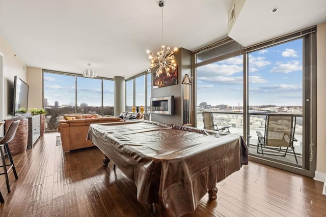 game room with dark wood-style floors, plenty of natural light, and floor to ceiling windows