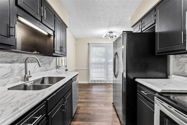 4146 Monclair Dr, Columbus, GA 31907 - kitchen with dark cabinetry, decorative backsplash, stainless steel appliances, a textured ceiling, and dark wood-style flooring