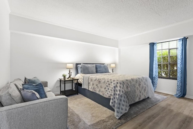 bedroom featuring hardwood / wood-style flooring and a textured ceiling