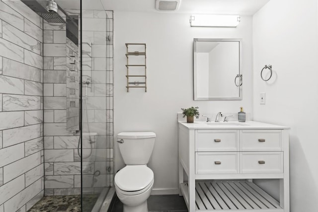 bathroom with an enclosed shower, vanity, and toilet