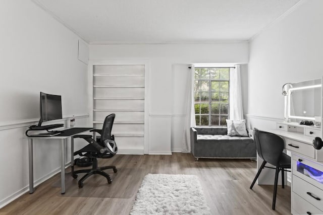 home office with crown molding and hardwood / wood-style flooring