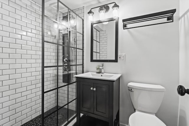 bathroom featuring an enclosed shower, vanity, and toilet