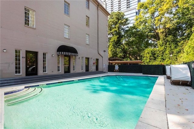 view of swimming pool with a patio