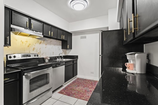 kitchen featuring appliances with stainless steel finishes, sink, and light tile patterned floors