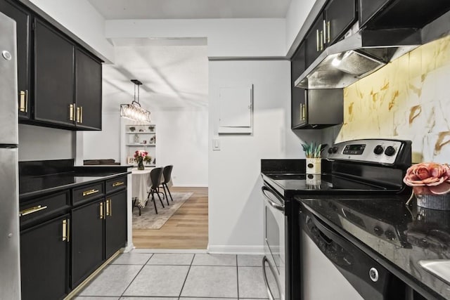 kitchen with light tile patterned flooring, hanging light fixtures, stainless steel range with electric stovetop, dark stone countertops, and a notable chandelier