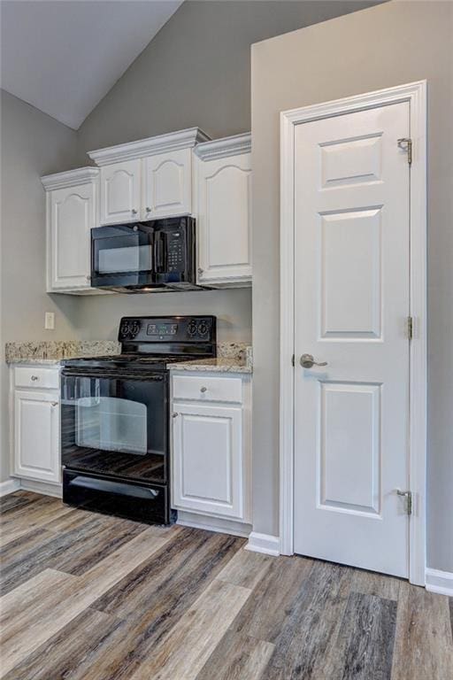 154 Jerry Allen Rdg, Dallas, GA 30132 - kitchen featuring black appliances, light wood finished floors, white cabinets, vaulted ceiling, and baseboards