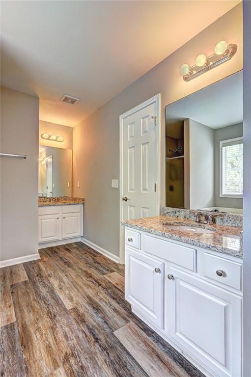 154 Jerry Allen Rdg, Dallas, GA 30132 - full bathroom with wood finished floors, two vanities, and baseboards