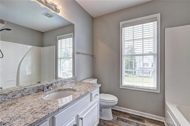 154 Jerry Allen Rdg, Dallas, GA 30132 - bathroom with toilet, vanity, wood finished floors, baseboards, and bathtub / shower combination